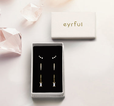 Gold hoop earrings encased with diamond pair with diamond climber stud earrings in gift box