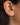 A diamond earring set of 3 in gold vermeil on model's ear.