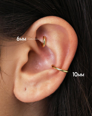 solid clicker hoop earrings as rook and conch earrings on model