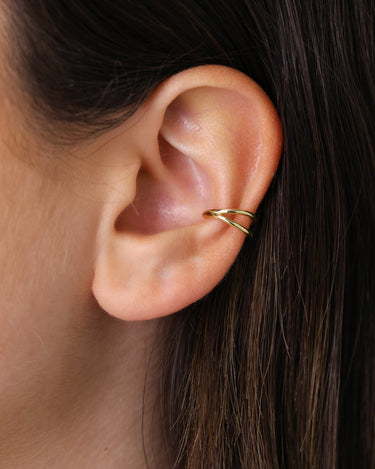 Solid double clicker hoop earrings in 18K gold as conch earrings on model 